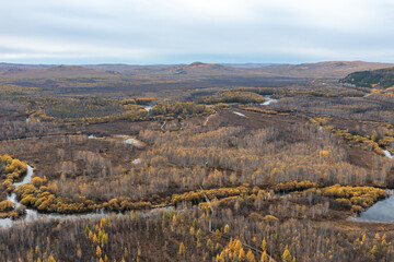 Aerial view of the autumn forest and river in the Shibawan scenic area of ​​Mohe, Greater Khingan Mountains.