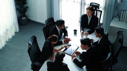 Top view of diverse business team discuss about marketing idea while businessman analyze financial graph from tablet at meeting room. Group of smart team brainstorm idea at conference. Directorate. - Powered by Adobe