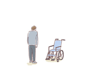 車椅子を見つめる男性の後ろ姿