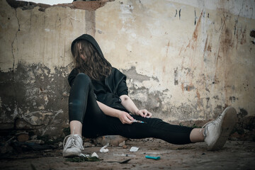 Addict with syringe wants to do an injection into a vein while in the old dirty crack house. female...