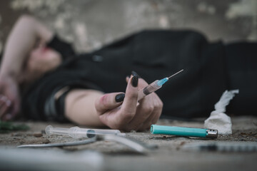Addict with syringe wants to do an injection into a vein while in dirty crack house. female drug...