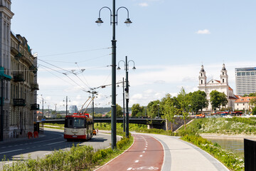 Beautiful city streets on a sunny summer day. Historic buildings among green trees in European city. 1 June 2025, Vilnius, Lithuania