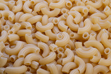 Uncooked spiral pasta provides nutrition, Plain raw macaroni offers necessary diet information, Unprocessed shaped pasta delivers key nutrients and energy sources