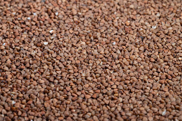 Fototapeta premium Buckwheat grains detailed, Textural image showcasing buckwheat groats texture, Highresolution closeup capturing natural appearance and tactile quality of buckwheat groats