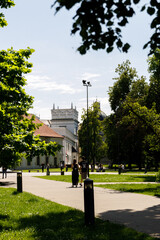 Beautiful city streets on a sunny summer day. Historic buildings among green trees in European city. 1 June 2025, Vilnius, Lithuania