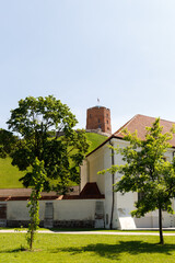 Beautiful city streets on a sunny summer day. Historic buildings among green trees in European city. 1 June 2025, Vilnius, Lithuania