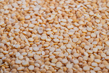 Heaped split peas ready for soup, cozy kitchen mood with implied home cook stirring pot, warm lighting suggesting comfort meal, traditional recipe ingredient focus