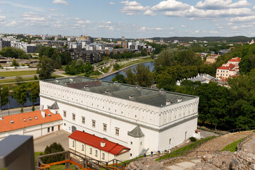 Historic buildings among green trees in a European city. A panoramic bird's-eye view of the historic city from the window of a tall old castle. June 1, 2025, Vilnius, Lithuania.