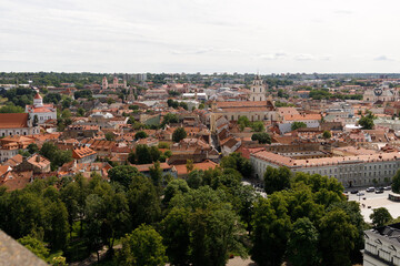 Beautiful city streets on a sunny summer day. Historic buildings among green trees in a European city. A panoramic view of the historic city from a bird's-eye perspective. June 1, 2025, Vilnius, Lithu