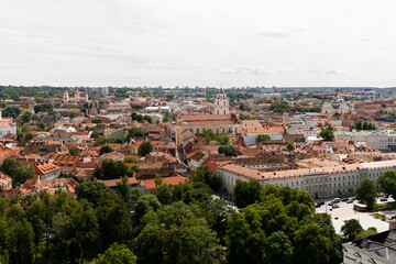 Beautiful city streets on a sunny summer day. Historic buildings among green trees in a European city. A panoramic view of the historic city from a bird's-eye perspective. June 1, 2025, Vilnius, Lithu