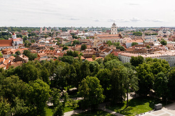Beautiful city streets on a sunny summer day. Historic buildings among green trees in a European city. A panoramic view of the historic city from a bird's-eye perspective. June 1, 2025, Vilnius, Lithu