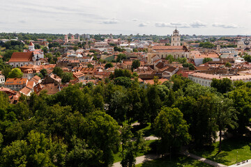 Beautiful city streets on a sunny summer day. Historic buildings among green trees in a European city. A panoramic view of the historic city from a bird's-eye perspective. June 1, 2025, Vilnius, Lithu