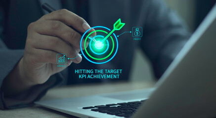 Businessman points to "Hitting the Target" hologram, digital dartboard interface showing "KPI achievement", profit and growth for business success, accuracy, focus, strategy, goal achievement.