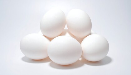 Close-up of six white eggs stacked in a pyramidal arrangement