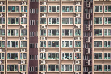 A dense urban landscape of high rise apartments and skyscrapers with varied designs and overhead cables stretching across the skyline.