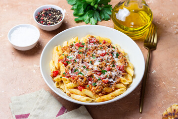 Pasta with bolognese sauce and cheese. Italian cuisine. Traditional recipe.