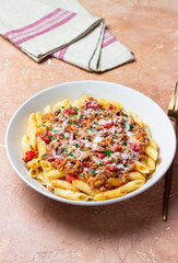 Pasta with bolognese sauce and cheese. Italian cuisine. Traditional recipe.