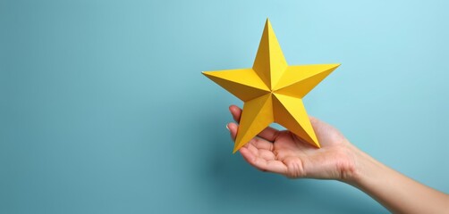 Hand holds a bright yellow star. Symbolizes achievement, recognition, excellent service, and positive feedback. Represents top quality rating and success.