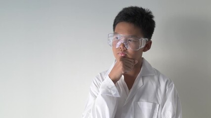 Young Asian Boy Dressed as Scientist with Lab Coat Thinking Wearing Protective Glasses