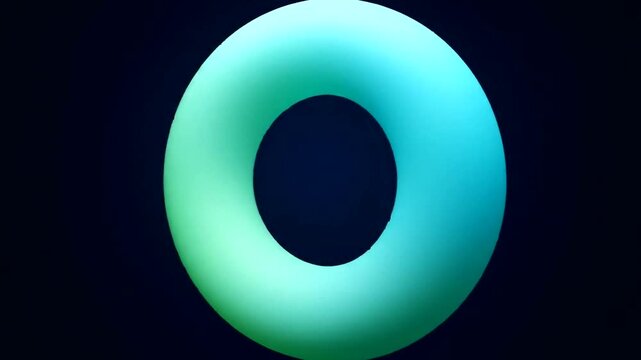 Abstract glowing torus shape against a dark background, emphasizing light effects