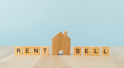 Wooden blocks and mini house, buy or rent home concept. Real estate