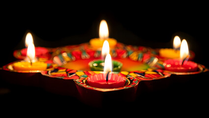 Traditional diwali oil lamps illuminated in the dark for celebration