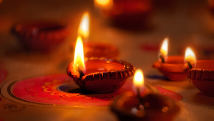 Close up of traditional indian diyas lit for diwali festival celebration