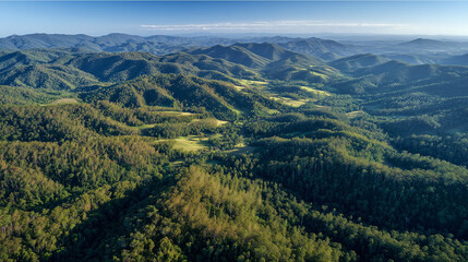 Fototapeta premium Aerial View Of Vast Forested Mountains And Lush Valleys From Above