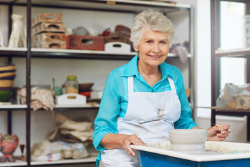 Pottery wheel, old woman and portrait in workshop with tools, handcraft and creative design. Potter, ceramic art and happy elderly person in studio for hobby, mold or sculpting clay in retirement