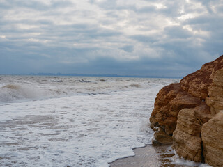 Sea Foam Waves Eroded reddish-brown Rock Coast