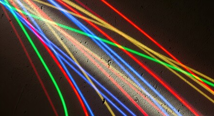 Colorful light streaks cast vibrant shadows on a textured wall creating a modern abstract design with dynamic lines and playful energy for backgrounds and creative projects