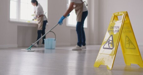Janitorial team cleaning service industry working, professional people washing floor, window sill, cleaning building, office space, mopping, housekeeping job, yellow caution wet floor board standing