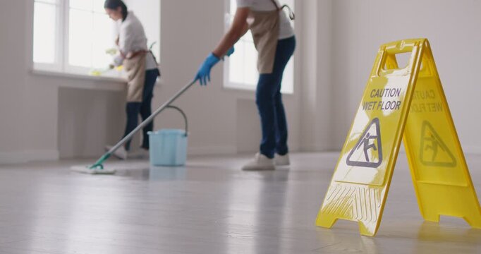 Janitorial team cleaning service industry working, professional people washing floor, window sill, cleaning building, office space, mopping, housekeeping job, yellow caution wet floor board standing