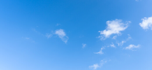 Low angle view and full frame of beautiful blue sky with strange shape of fluffy white clouds in the afternoon on sunny day used as natural background texture in decorative art work