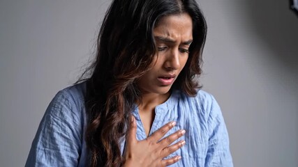 Woman Experiencing Chest Pain or Discomfort, Showing Symptoms of Anxiety or Distress