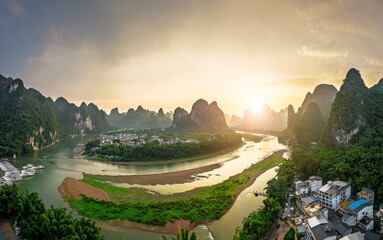 Obraz premium Aerial view of beautiful karst mountains and winding river at sunset in Guilin.