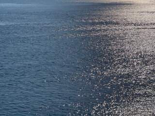 Glittering ocean blue water background.
