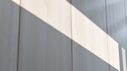 Obraz premium Smooth concrete wall with subtle shadows, emphasizing modern architectural texture.