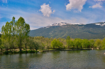 El Paular river flowing through mountains landscape
