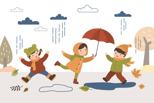 Fall, kids in autumn park. Children outdoor activity. Boy and girls play with falling leaves. Little people in warm clothes jump over puddles. October and november defoliation