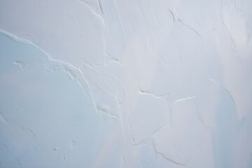 White textured surface with subtle variations in tone creating a smooth and calming effect