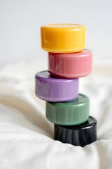 Colorful stacked containers on white fabric creating a visually appealing arrangement and balance