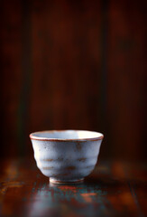 Traditional japanese ceramic on rustic wooden background. Soft focus. Copy space.	