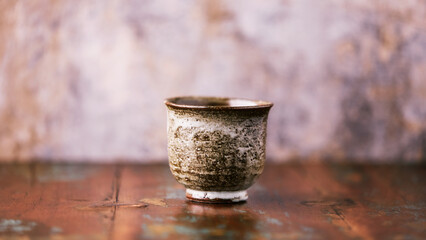Traditional japanese ceramic on rustic wooden background. Soft focus. Copy space.