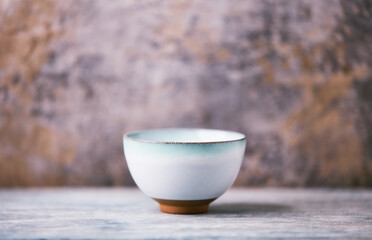Traditional japanese ceramic on rustic wooden background. Soft focus. Copy space.	
