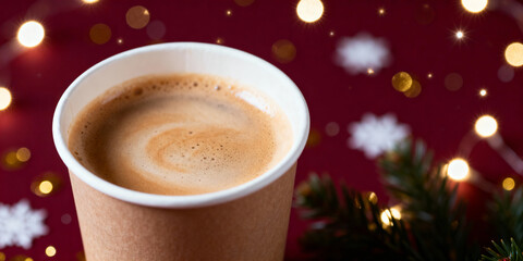 Holiday-themed coffee cup closeup with glowing bokeh lights