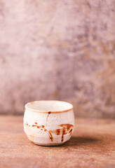 Traditional japanese ceramic on rustic wooden background. Soft focus. Copy space.	