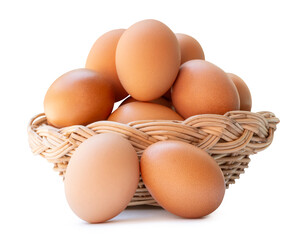 Many brown chicken eggs in stack in wicker basket isolated on white background with clipping path