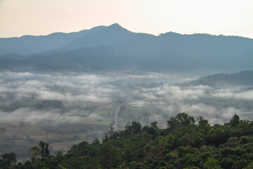 Morning mist in the mountains covering the village