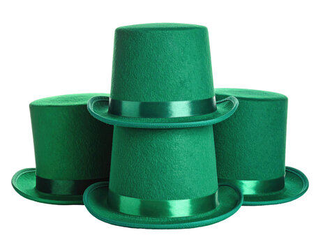 Three green top hats stacked on each other in varying positions, over a black background